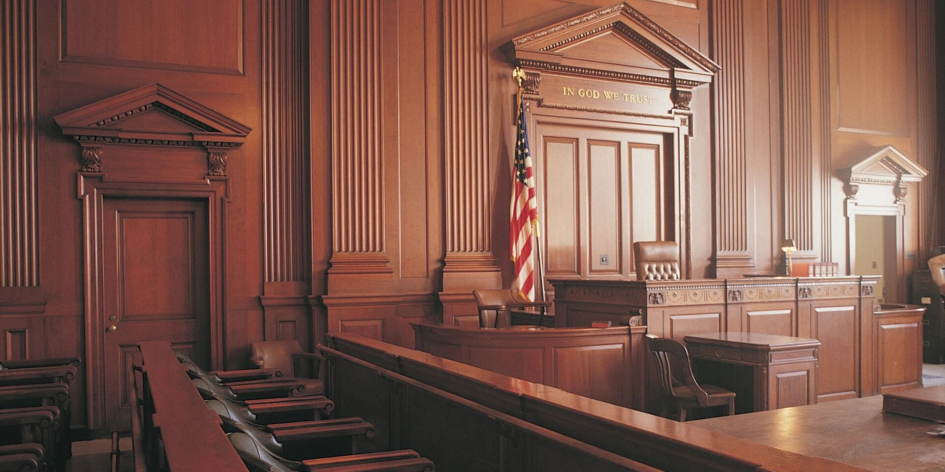 Inside of a courtroom with American flags
